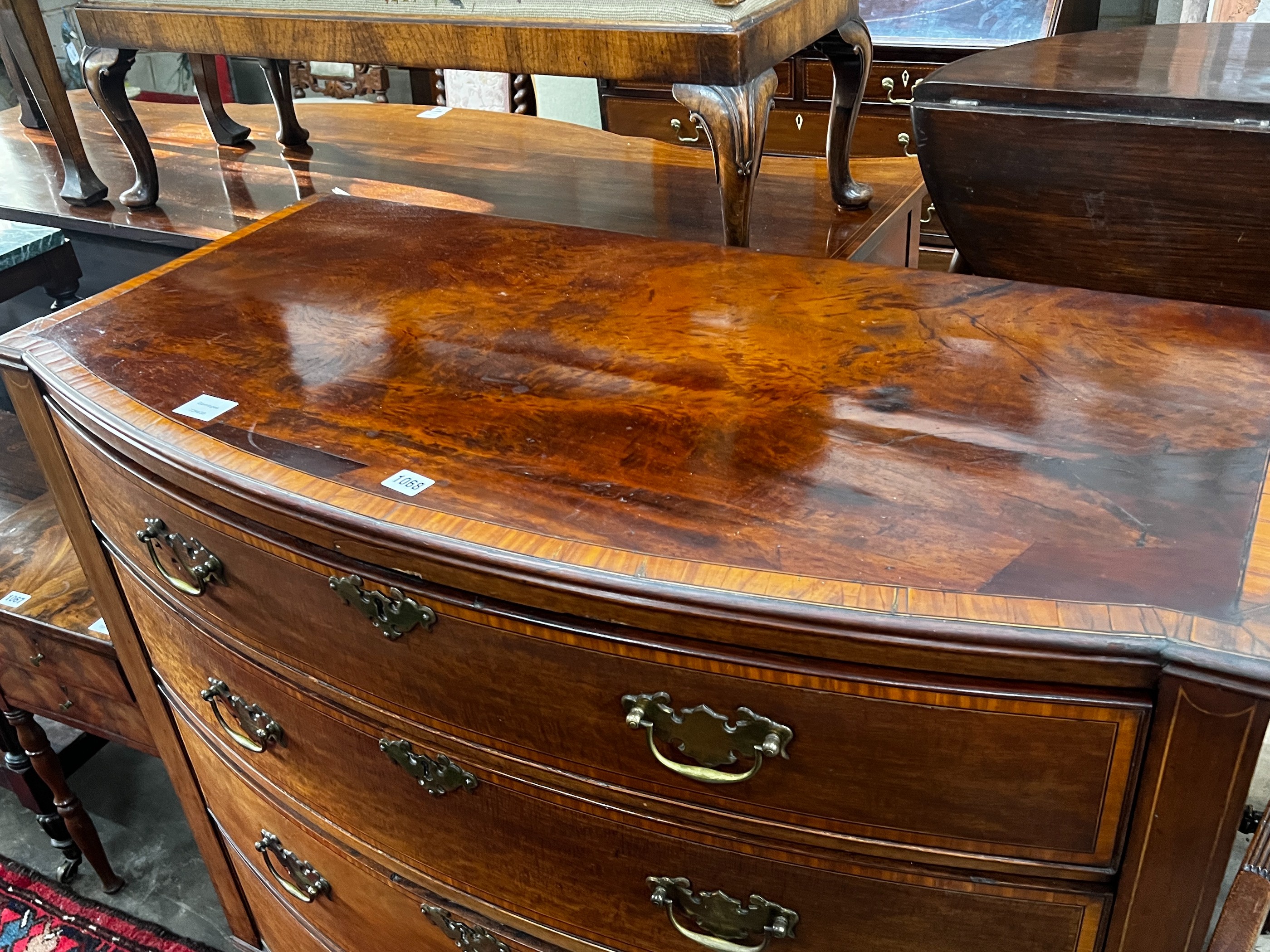 A George III satinwood banded mahogany bow front chest of drawers, width 109cm, depth 54cm, height 101cm